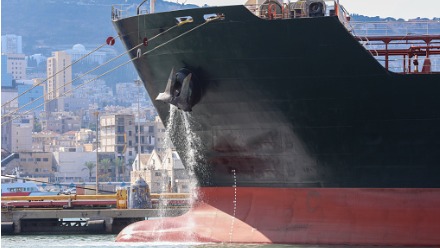 large-anchored-cargo-ship-discharging-ballast-water-out-from-anchors-hub-thumbnail.jpg